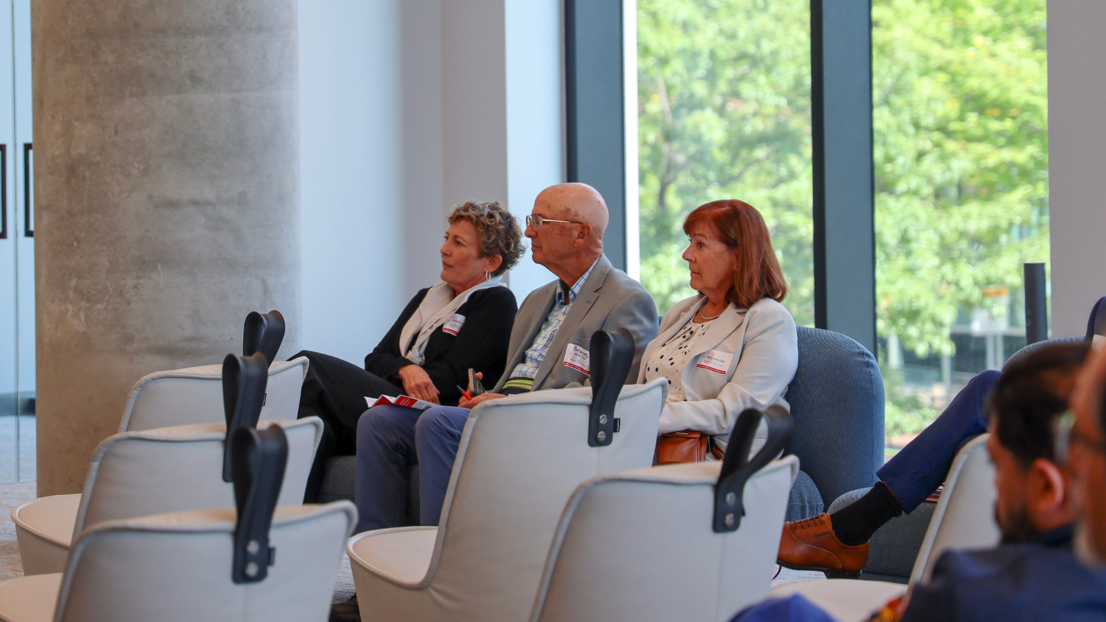 Jennifer Dale, Bruce Dale, and Mary Ann Dale sit together at the Mickey Dale Family Foundation symposium, pictured from left to right.