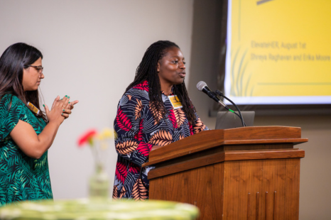 Erika Moore speaks at podium