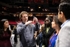 BIOE students gather during the 2026 Capstone Design Expo, with one student holding up a prototype while explaining the team’s project.