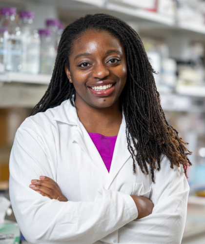Erika smiling at the camera in a lab