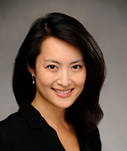 Catherine Kuo smiling at the camera in a professional portrait