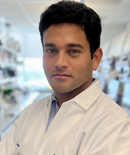 Rohan looking at the camera in a lab