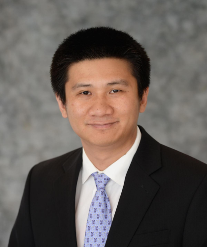 Yu Gan looking at the camera in a professional portrait